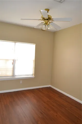 a view of a closet with wooden floor