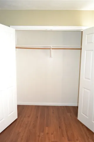 a view of a small space with wooden floor and a chandelier