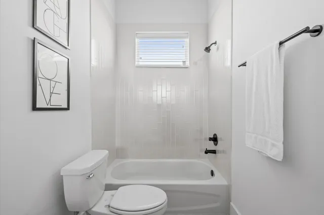 a bathroom with a toilet and a bathtub