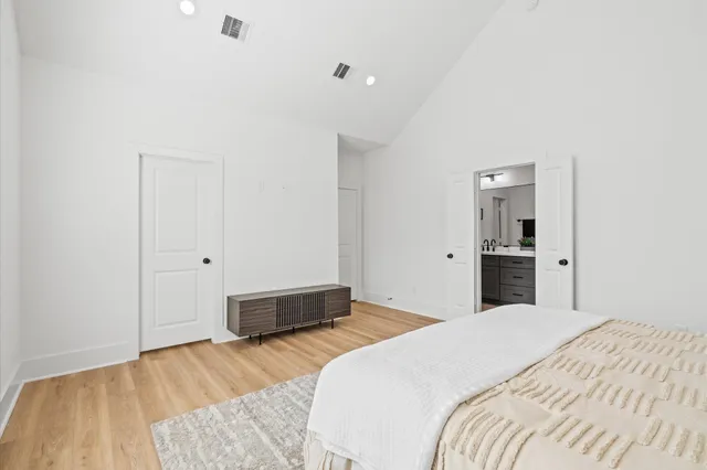 a bedroom with a bed and cabinets