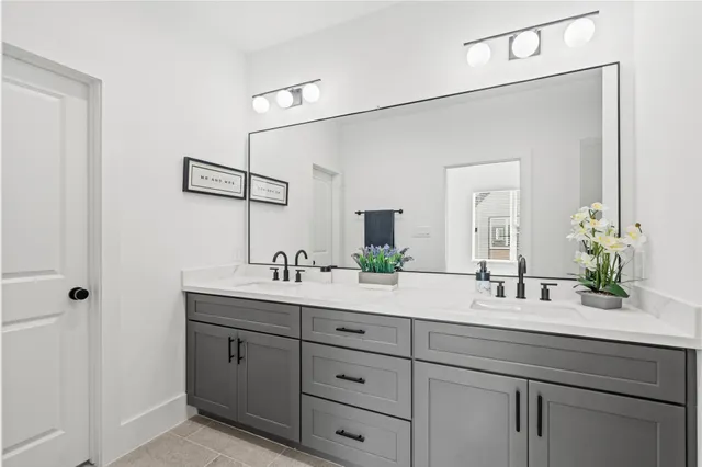a bathroom with double sink and a mirror