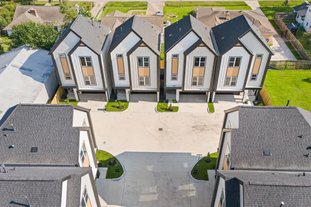 an aerial view of a house with a yard