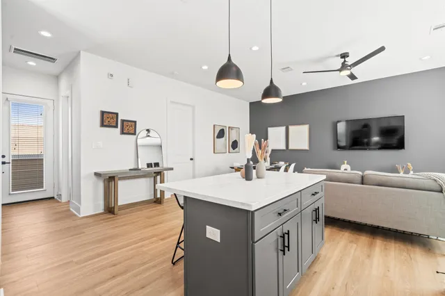 a large kitchen with a table and chairs