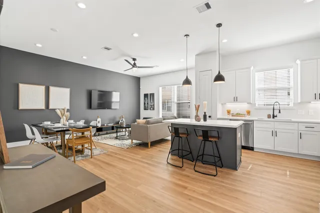 a large kitchen with a table and chairs in it