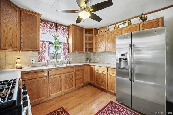 a kitchen with a refrigerator a sink and cabinets