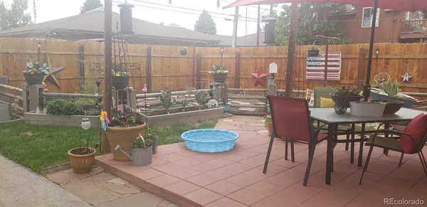 a view of a patio with a table and chairs
