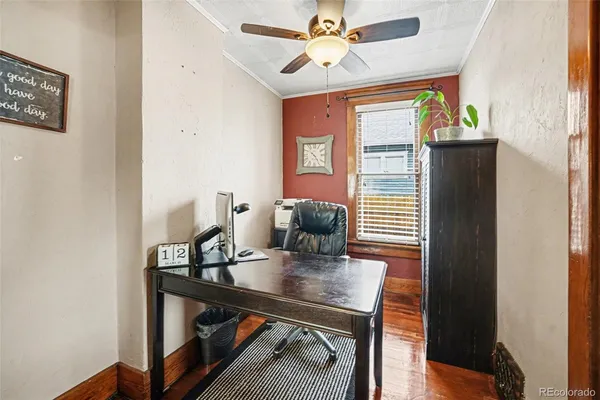 a view of a workspace with furniture and a window