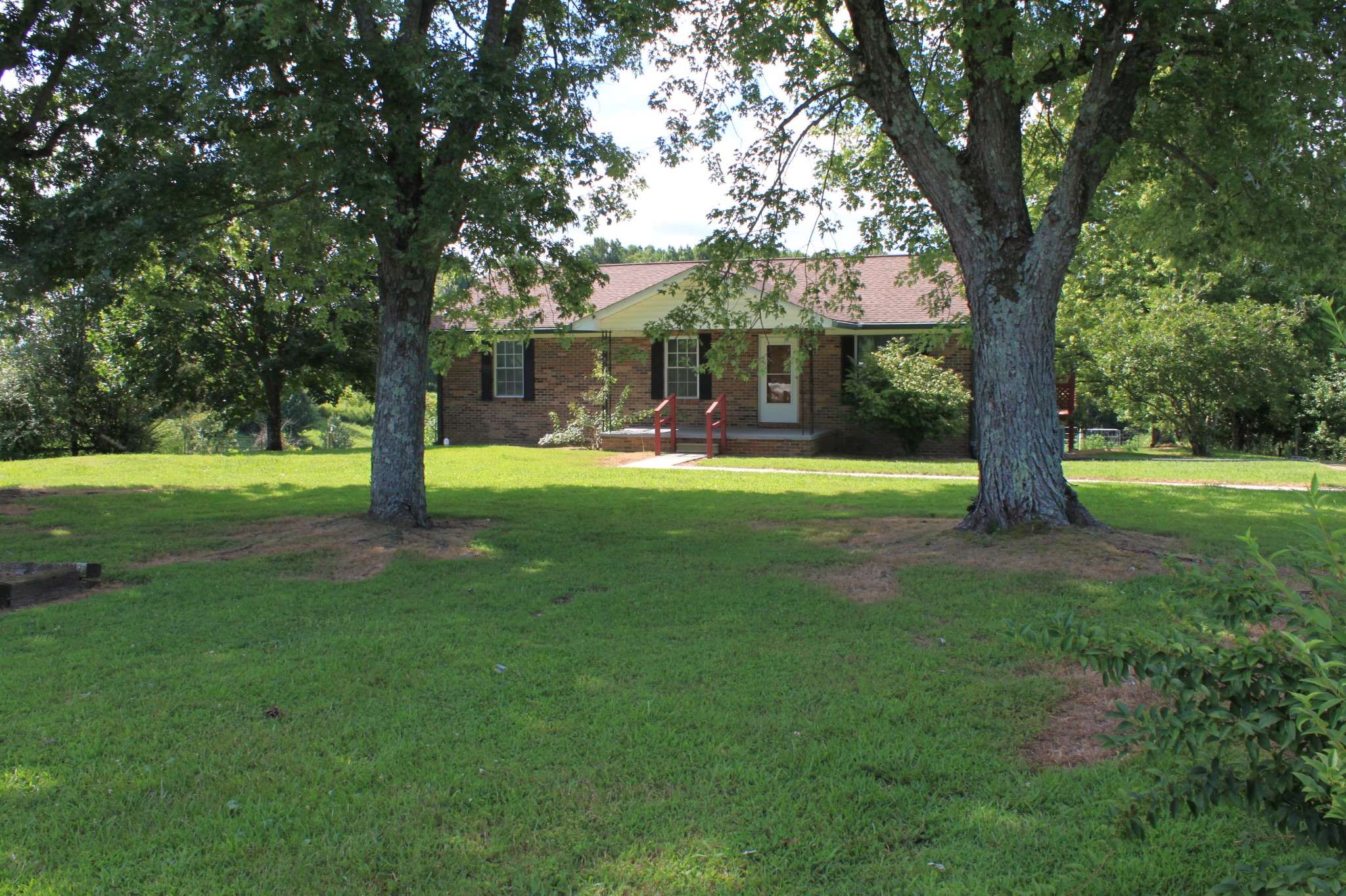 6923 Old Mill Hill Road Dowelltown, TN 37059 - Photo 14 of 43 a view of a house with a big yard and large trees