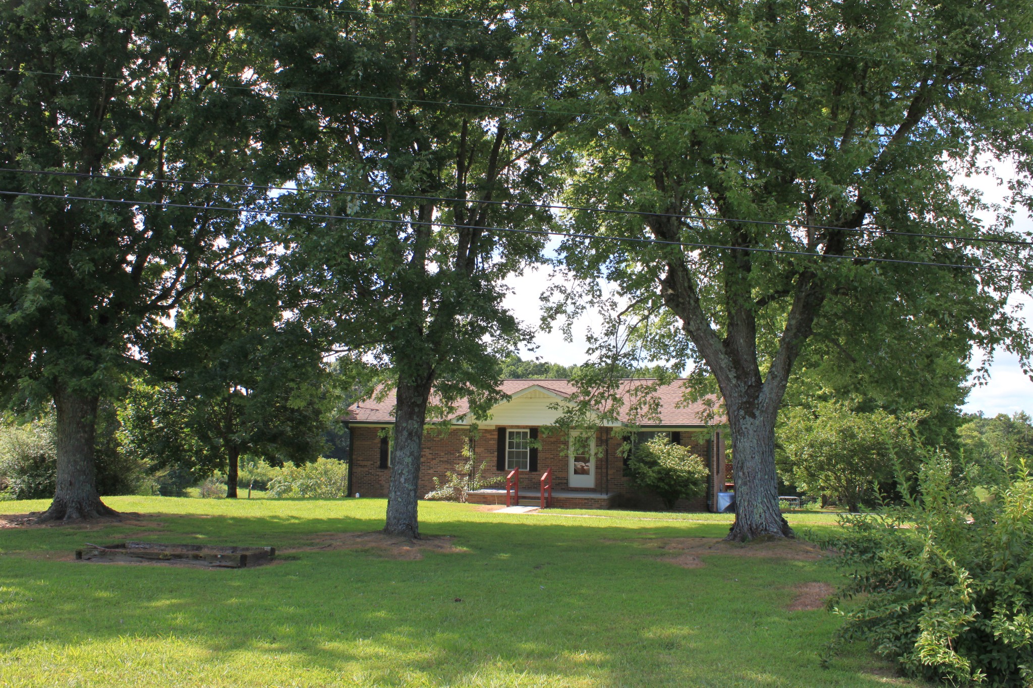 6923 Old Mill Hill Road Dowelltown, TN 37059 - Photo 15 of 43 a view of a house with a big yard and large trees