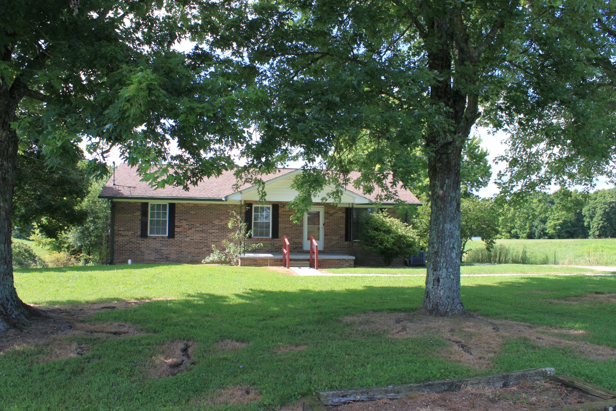 6923 Old Mill Hill Road Dowelltown, TN 37059 - Photo 7 of 43 a view of a house with a yard porch and sitting area