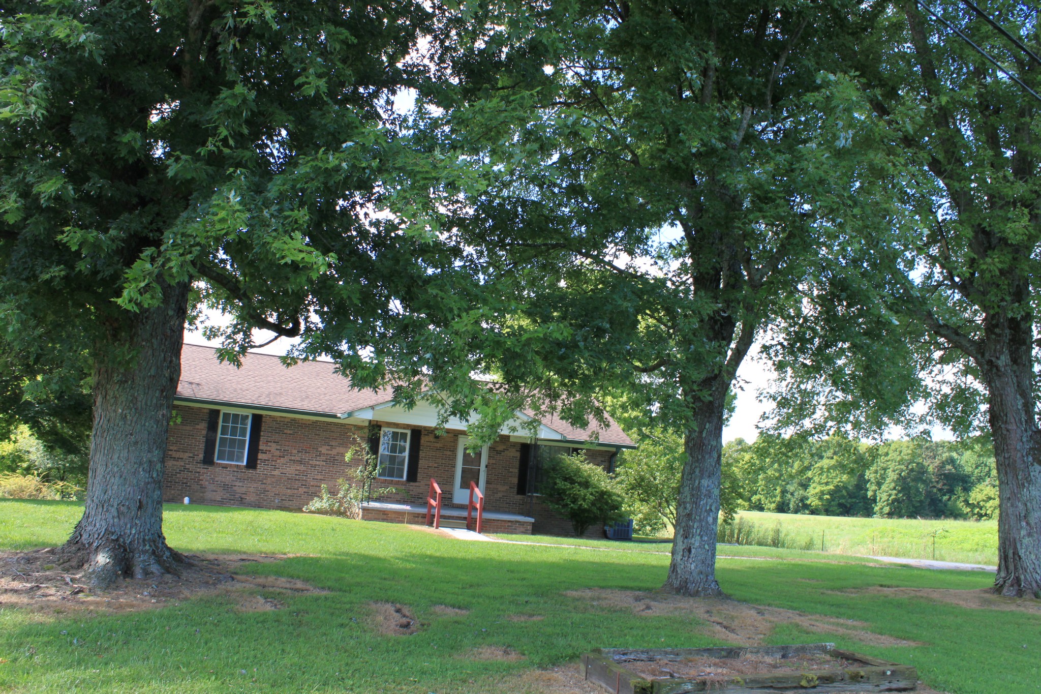 6923 Old Mill Hill Road Dowelltown, TN 37059 - Photo 10 of 43 a front view of a house with a garden and tree