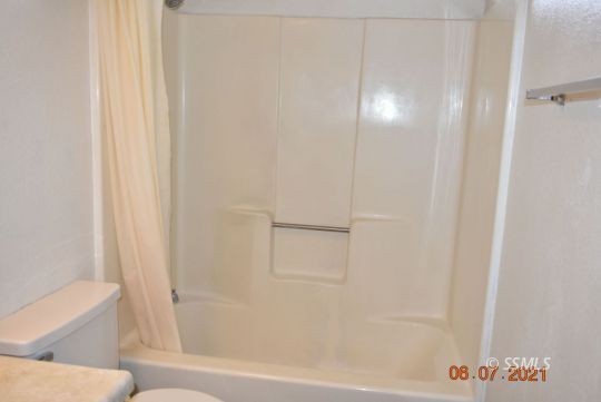 409 South Sunset Street Ridgecrest, CA 93555 - Photo 19 of 19 a bathroom with a bathtub and a toilet