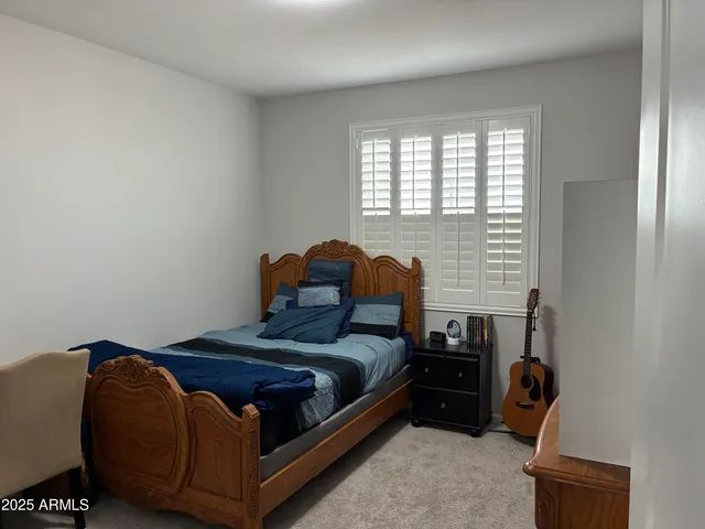 a bedroom with a bed and window