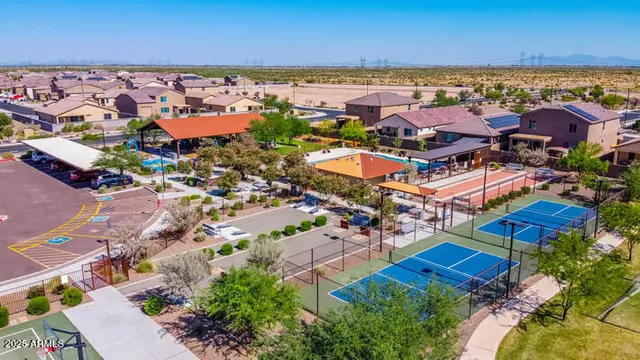 an aerial view of residential houses with outdoor space and ocean view
