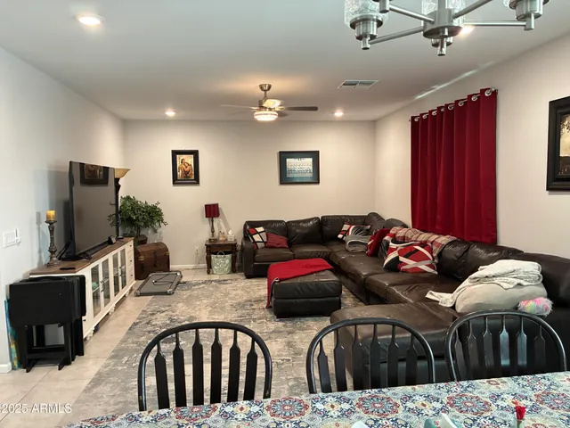 a bedroom with furniture and a flat screen tv