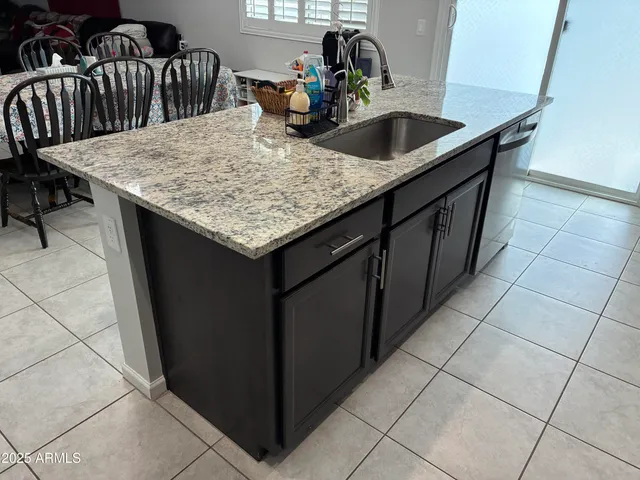 a kitchen with a sink a counter and utility room