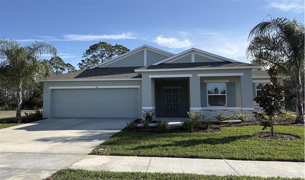 48 Enclave Avenue Palm Coast, FL 32164 - Photo 2 of 20 a front view of a house with a yard and garage
