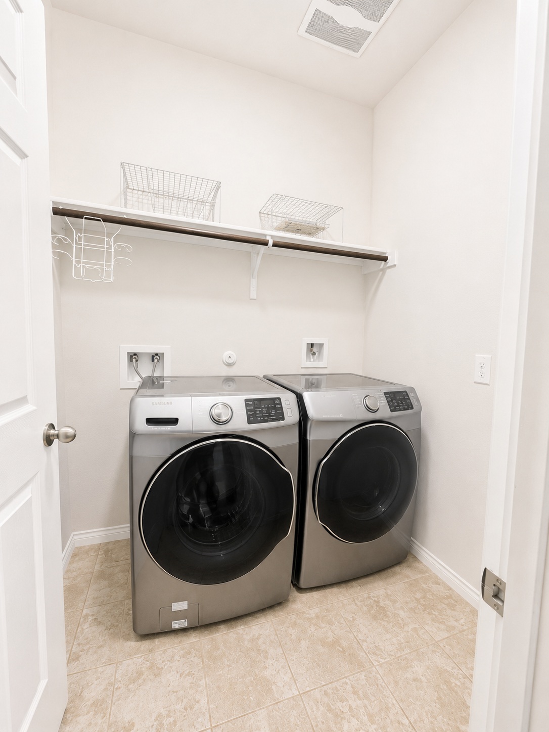 187 Limerick Road Buda, TX 78610 - Photo 16 of 18 Functional laundry room equipped with modern appliances and practical shelving.