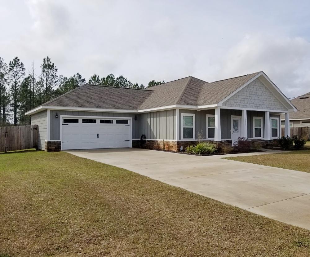 a front view of a house with a garden
