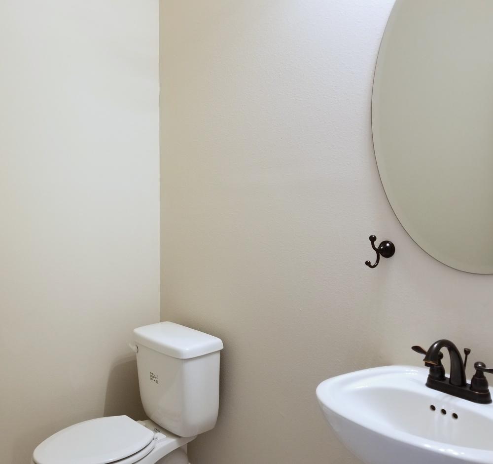 5618 Price Plantation Road Baker, FL 32531 - Photo 11 of 24 a white toilet sitting next to a white sink