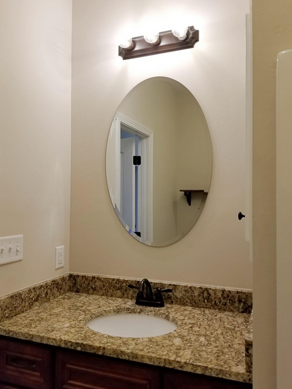 5618 Price Plantation Road Baker, FL 32531 - Photo 12 of 24 a bathroom with a granite countertop sink and a mirror