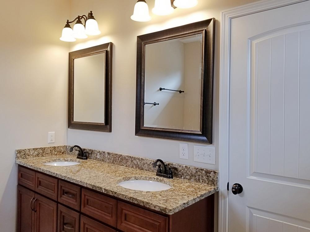 5618 Price Plantation Road Baker, FL 32531 - Photo 16 of 24 a bathroom with a granite countertop sink and a mirror