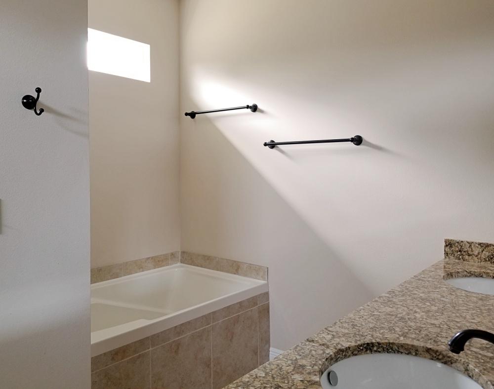 5618 Price Plantation Road Baker, FL 32531 - Photo 17 of 24 a bathroom with a tub and shower