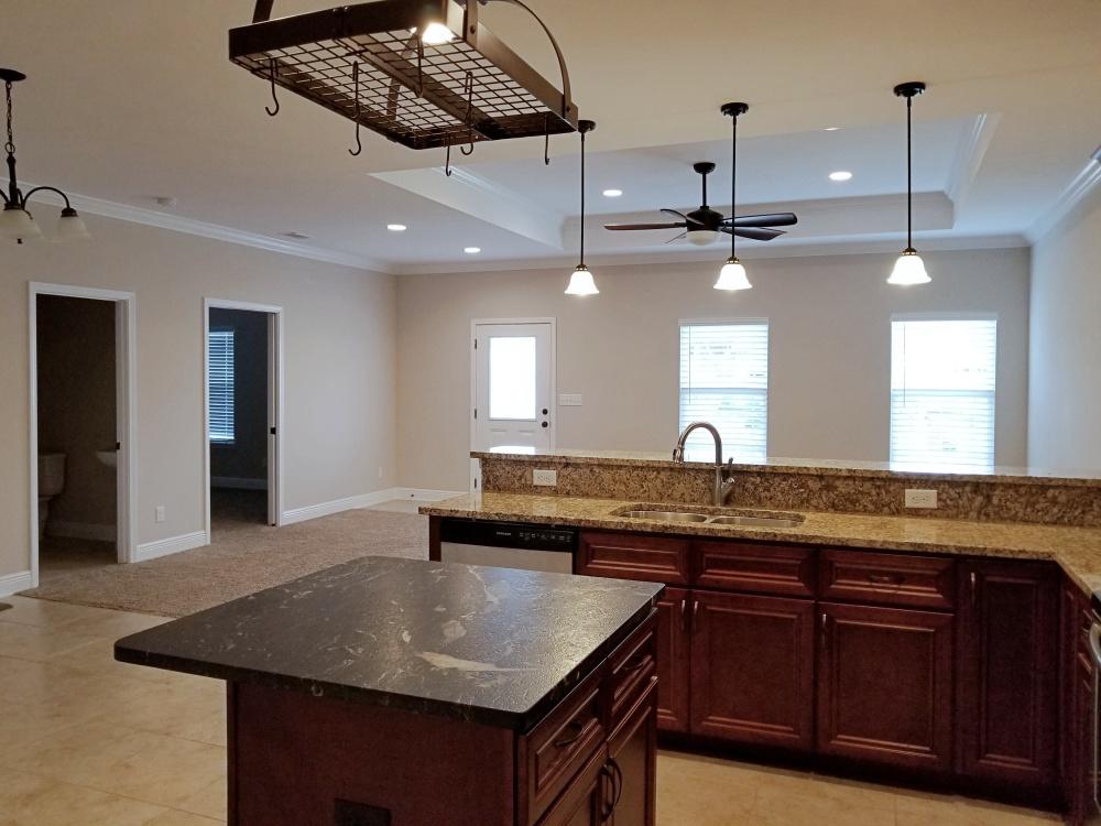 5618 Price Plantation Road Baker, FL 32531 - Photo 5 of 24 a kitchen with kitchen island granite countertop a sink a counter space and stainless steel appliances