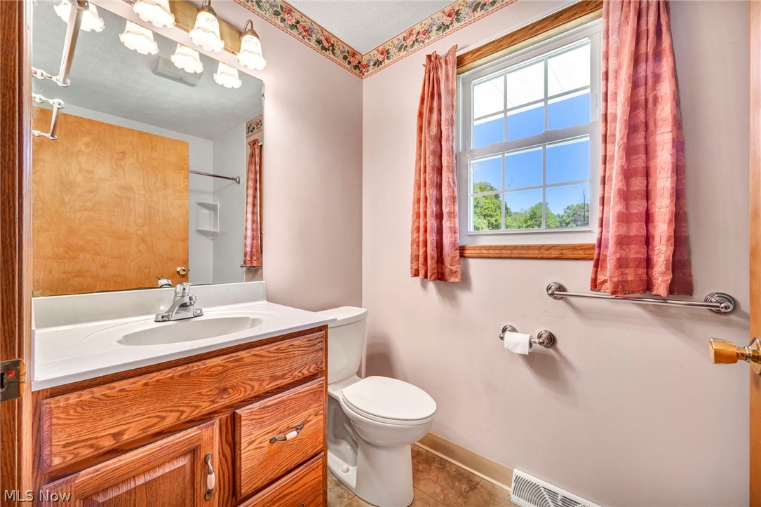 1927 Connect Road Barberton, OH 44203 - Photo 18 of 28 Bathroom featuring vanity, toilet, and tile patterned flooring