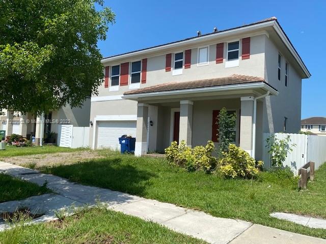 22953 Southwest 115th Avenue Miami, FL 33170 - Photo 1 of 1 a front view of a house with a garden and plants