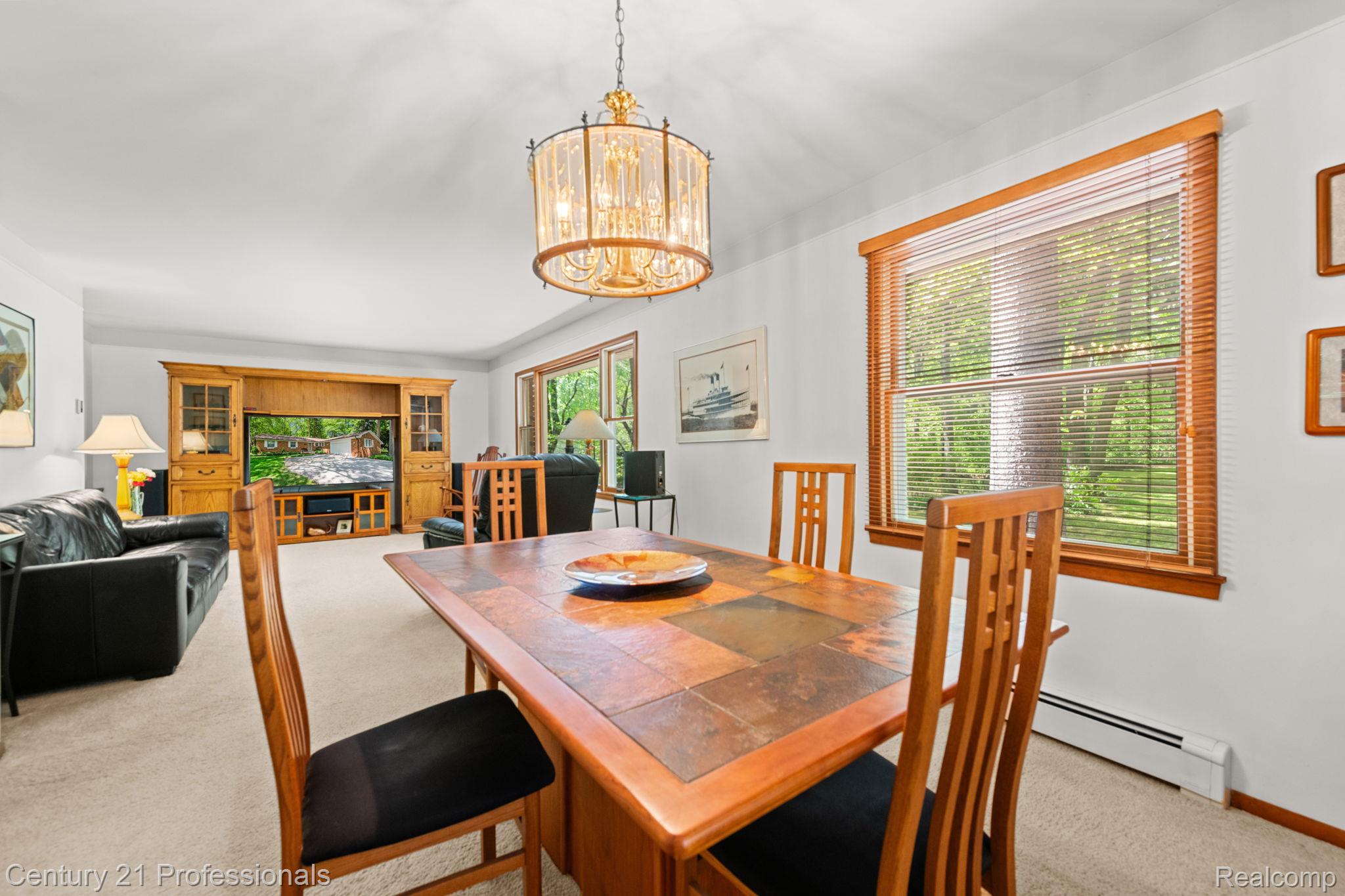 8638 Stone Road Algonac, MI 48001 - Photo 35 of 70 Dining space with light colored carpet, hanging lights, and baseboard heating