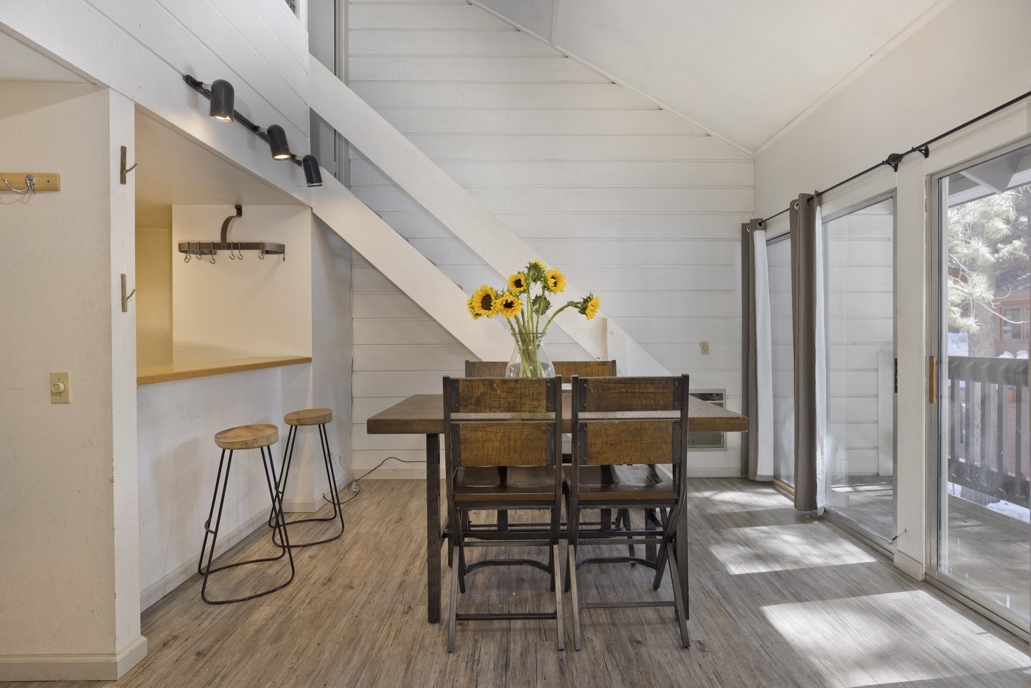 2289 Sierra Nevada Road, Unit G10 Mammoth Lakes, CA 93546 - Photo 2 of 23 Dining space with wooden walls, wood finished floors, and vaulted ceiling