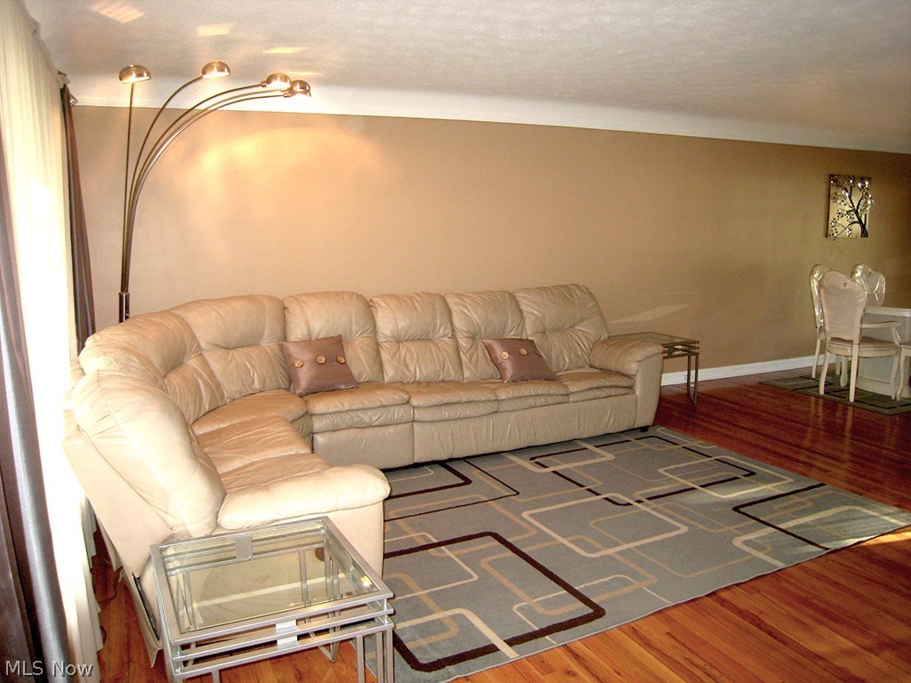 6925 Maplewood Road Parma Heights, OH 44130 - Photo 7 of 25 Hardwood floors and a large living room with airy and open light.