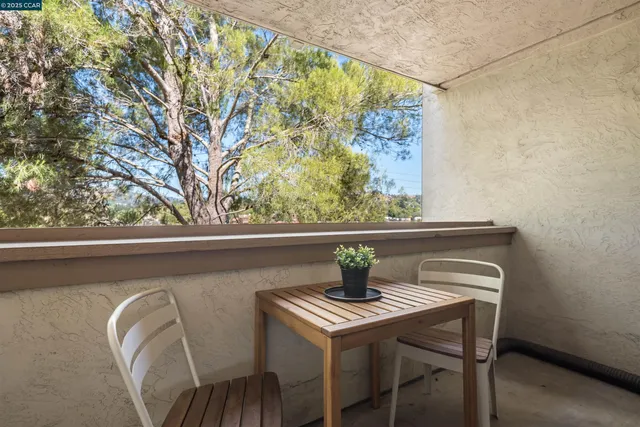 a view of outdoor dining space with a table and chairs