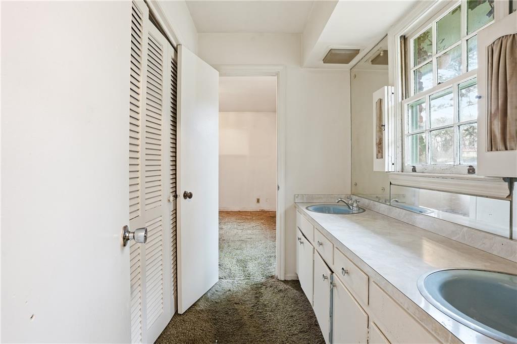 2935 Heather Drive East Point, GA 30344 - Photo 14 of 25 a bathroom with a granite countertop sink and a washing machine