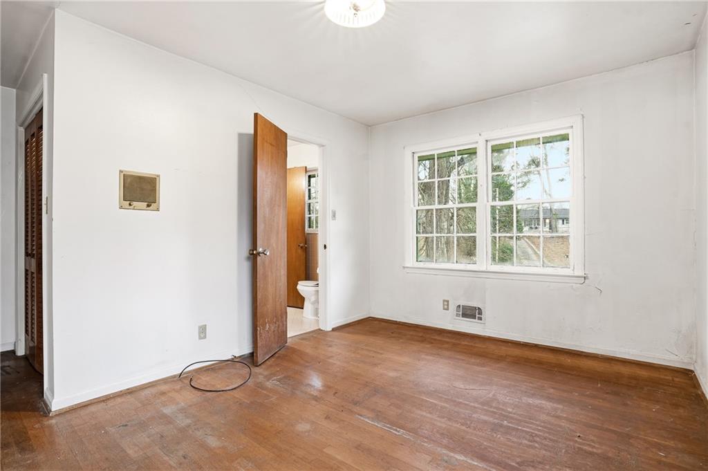 2935 Heather Drive East Point, GA 30344 - Photo 19 of 25 an empty room with wooden floor and windows