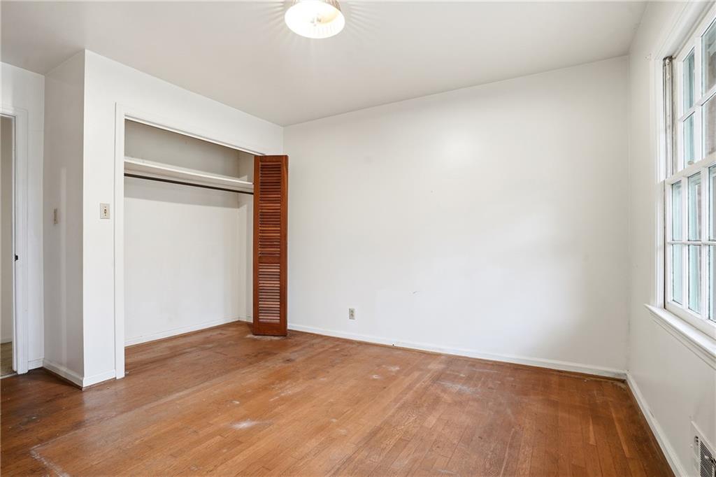2935 Heather Drive East Point, GA 30344 - Photo 22 of 25 an empty room with wooden floor and windows