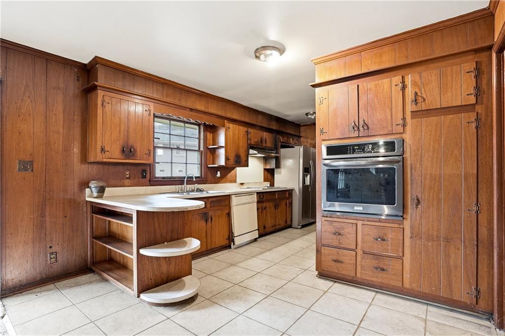 2935 Heather Drive East Point, GA 30344 - Photo 8 of 25 a kitchen with stainless steel appliances granite countertop a stove a sink and a refrigerator