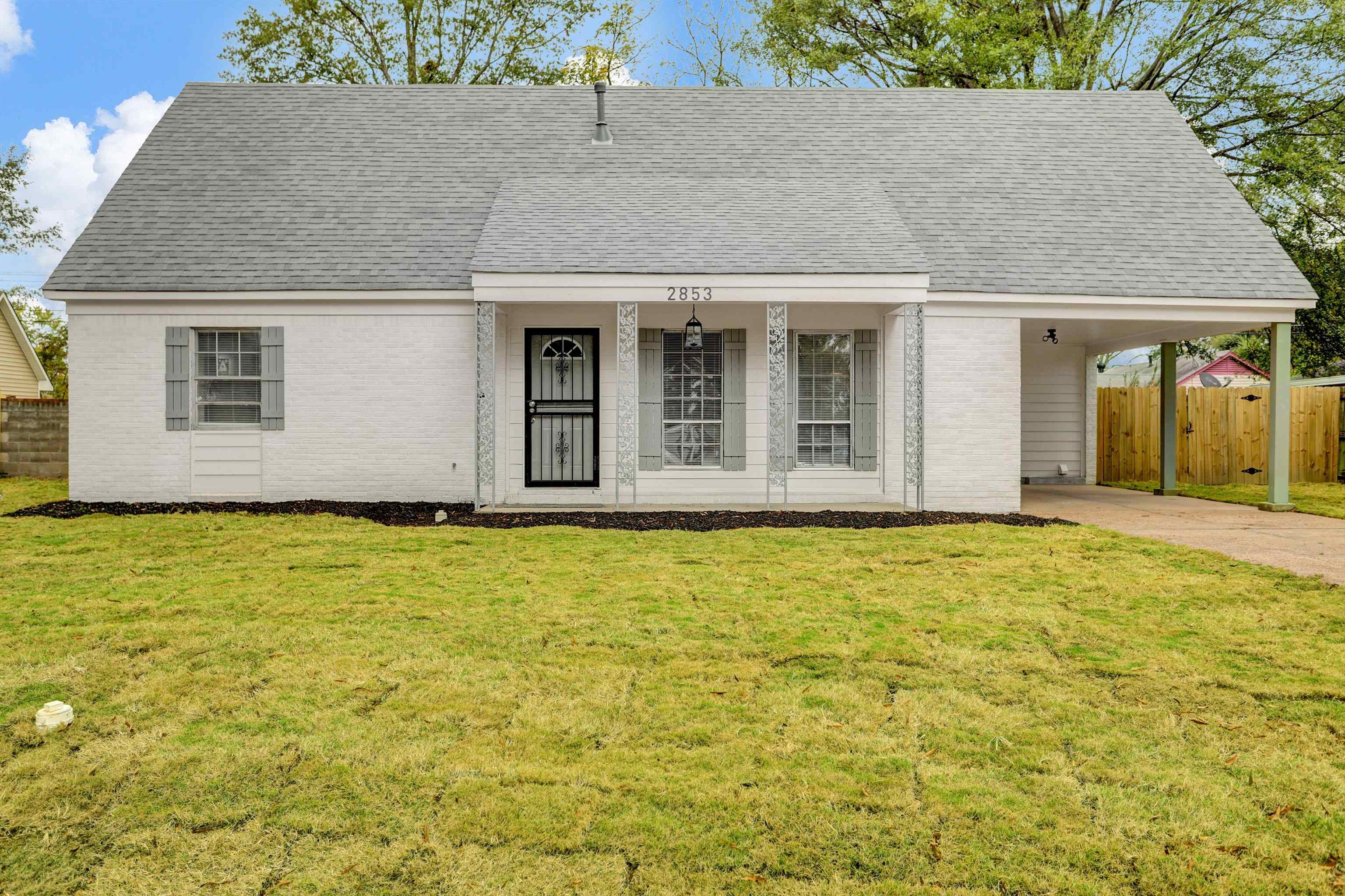 2853 Clearbrook Street Memphis, TN 38118 - Photo 1 of 30 View of front of home featuring brick siding, a shingled roof, fence, concrete driveway, and a front lawn