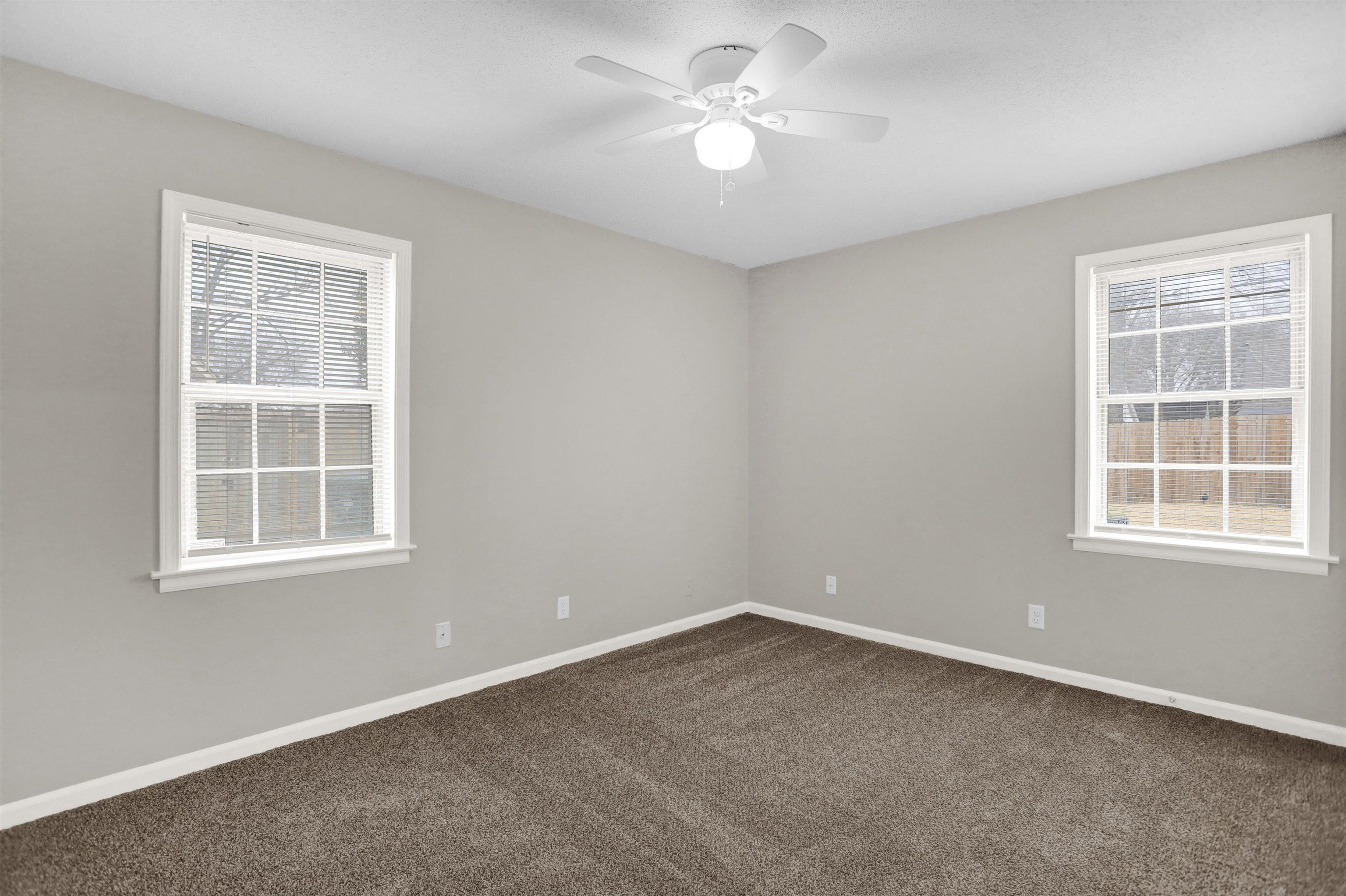 2853 Clearbrook Street Memphis, TN 38118 - Photo 16 of 30 Unfurnished room featuring dark carpet, baseboards, and ceiling fan