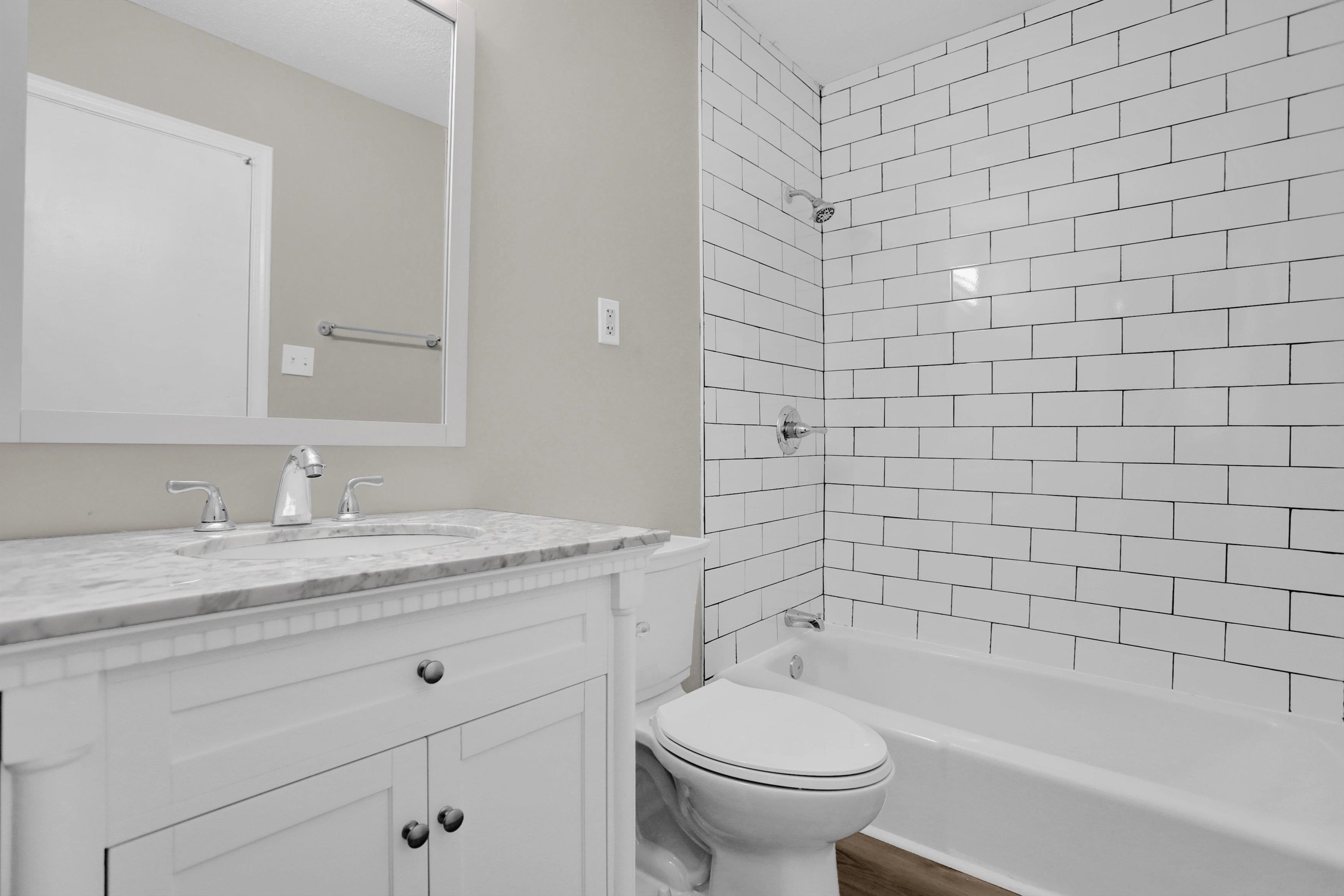 2853 Clearbrook Street Memphis, TN 38118 - Photo 18 of 30 Bathroom featuring wood finished floors, bathing tub / shower combination, vanity, and toilet