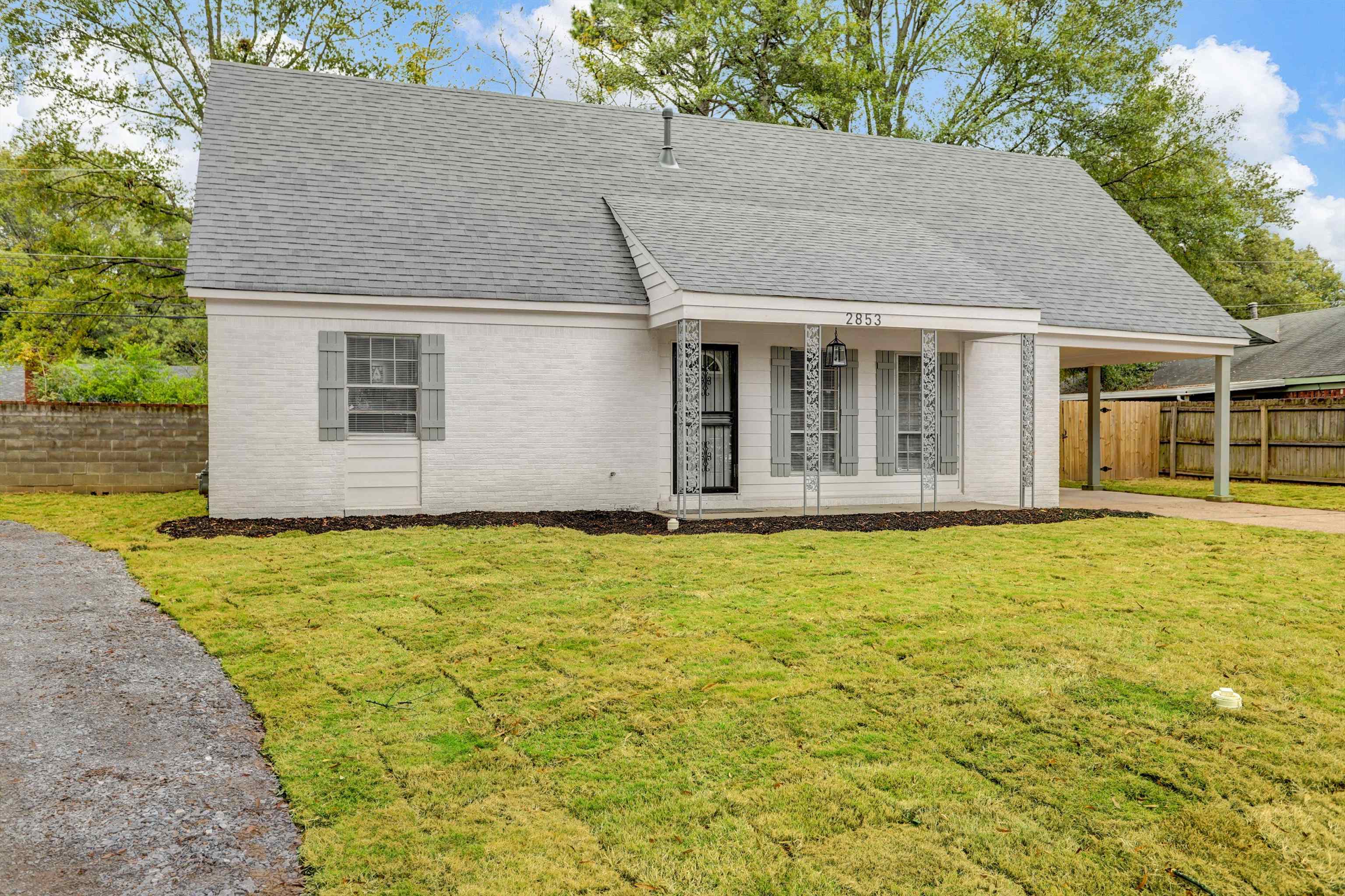 2853 Clearbrook Street Memphis, TN 38118 - Photo 2 of 30 View of front of property featuring brick siding, a shingled roof, concrete driveway, fence, and a front yard