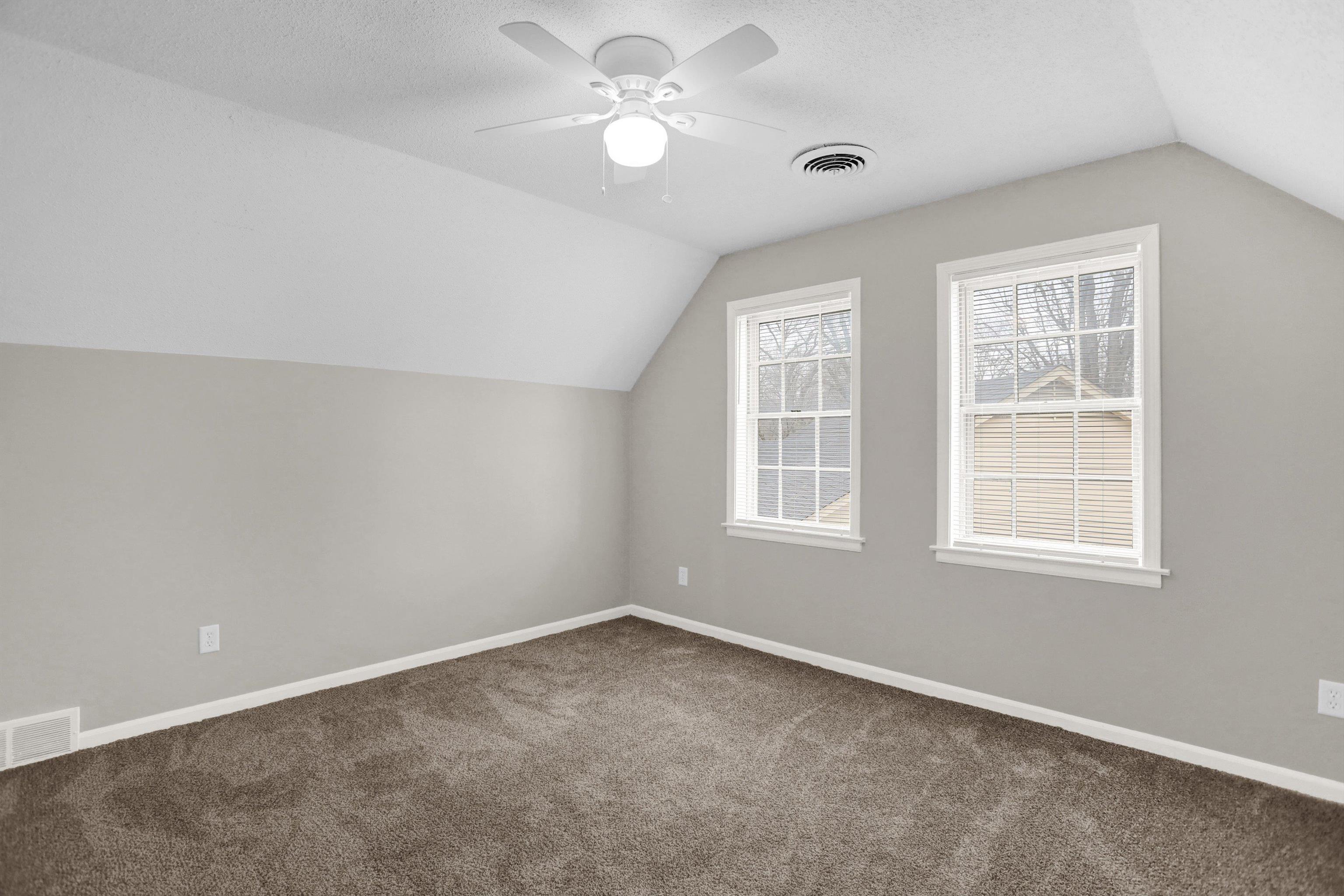 2853 Clearbrook Street Memphis, TN 38118 - Photo 22 of 30 Additional living space with carpet, visible vents, vaulted ceiling, and baseboards