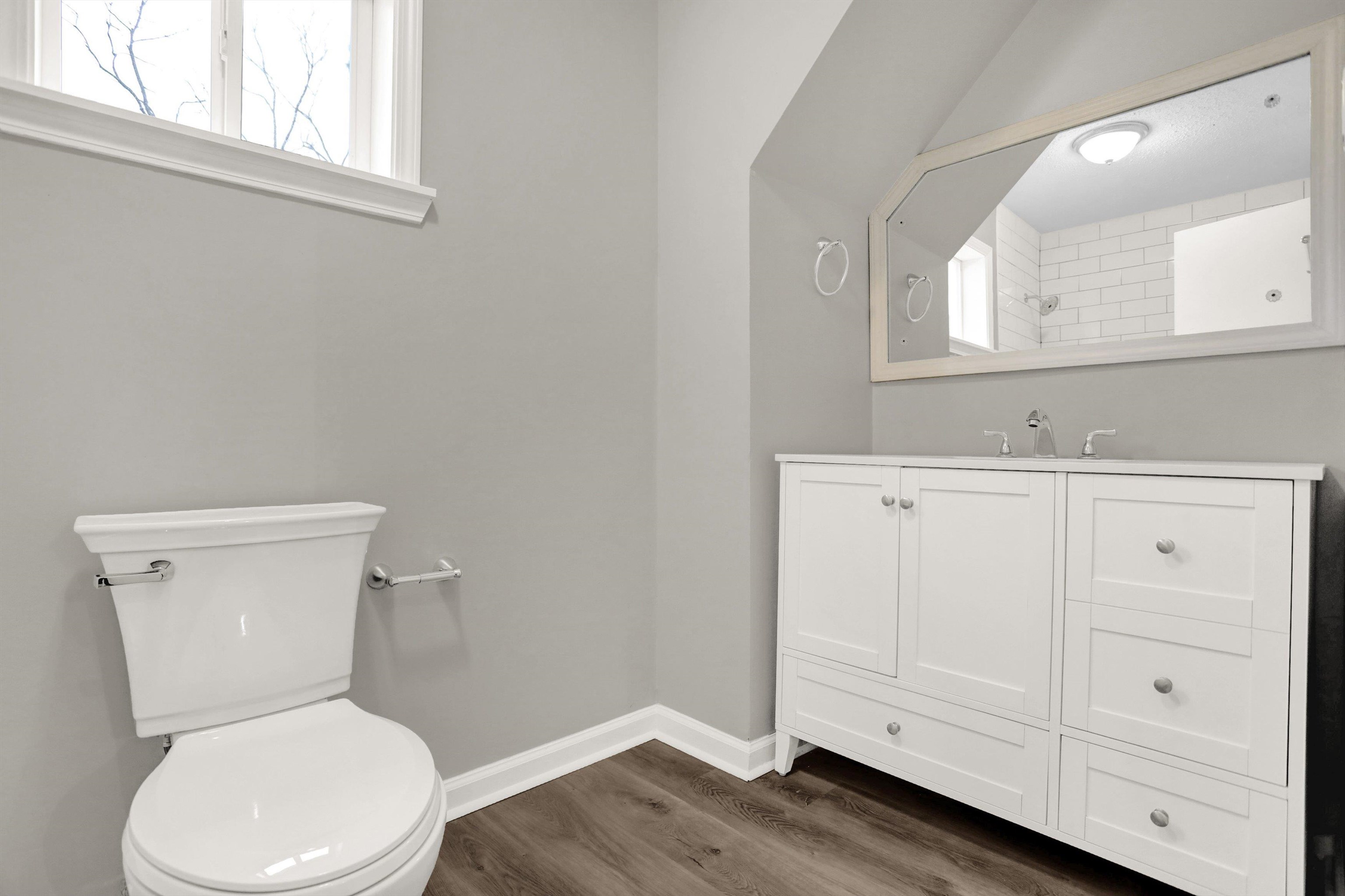 2853 Clearbrook Street Memphis, TN 38118 - Photo 24 of 30 Bathroom with baseboards, vanity, toilet, and wood finished floors