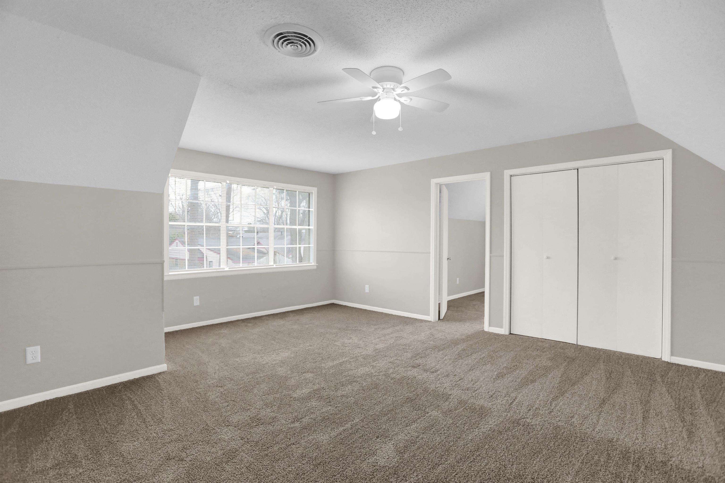 2853 Clearbrook Street Memphis, TN 38118 - Photo 25 of 30 Unfurnished bedroom with a textured ceiling, carpet floors, visible vents, vaulted ceiling, and a closet