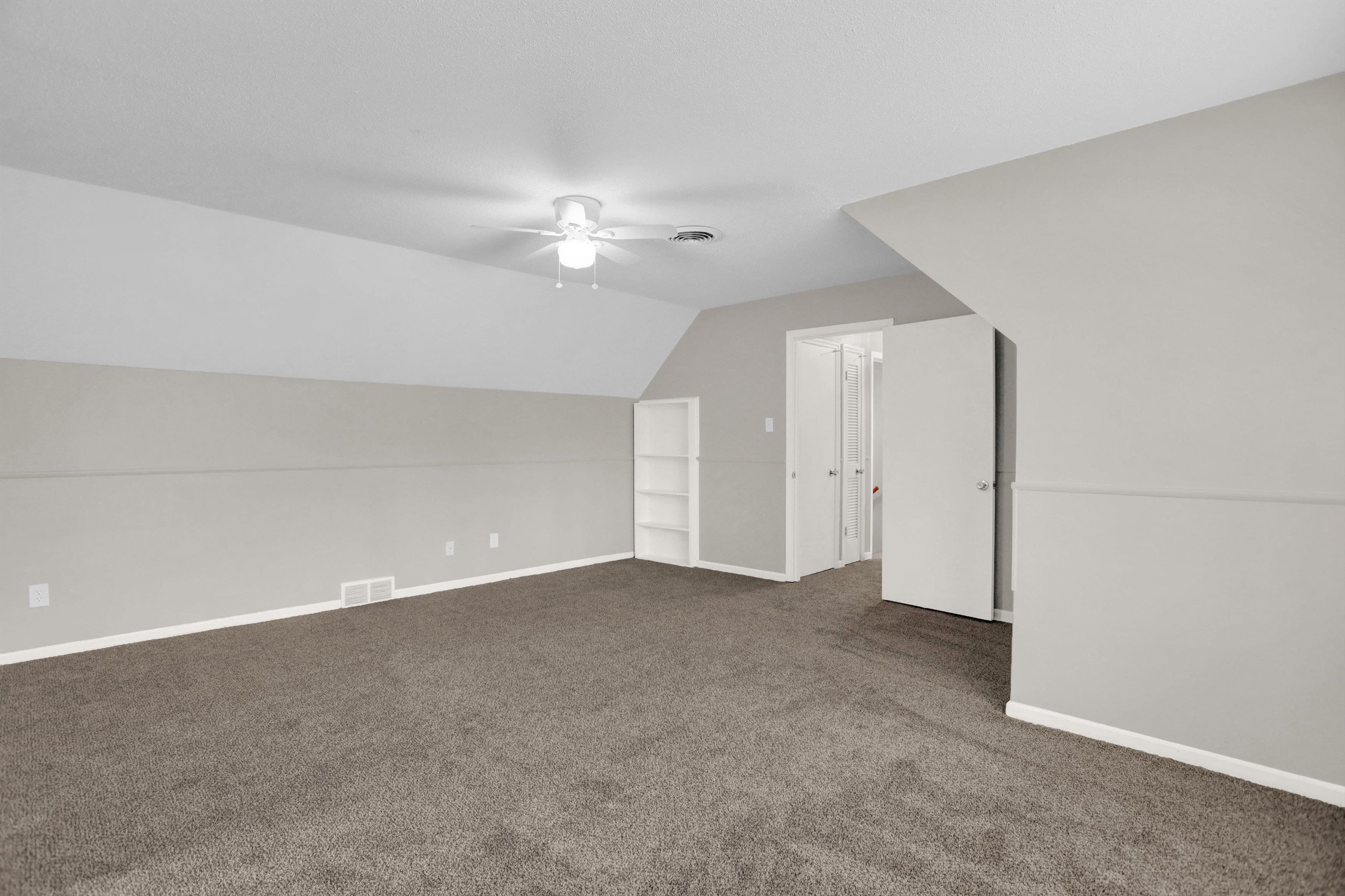 2853 Clearbrook Street Memphis, TN 38118 - Photo 27 of 30 Additional living space featuring a ceiling fan, visible vents, vaulted ceiling, baseboards, and dark colored carpet