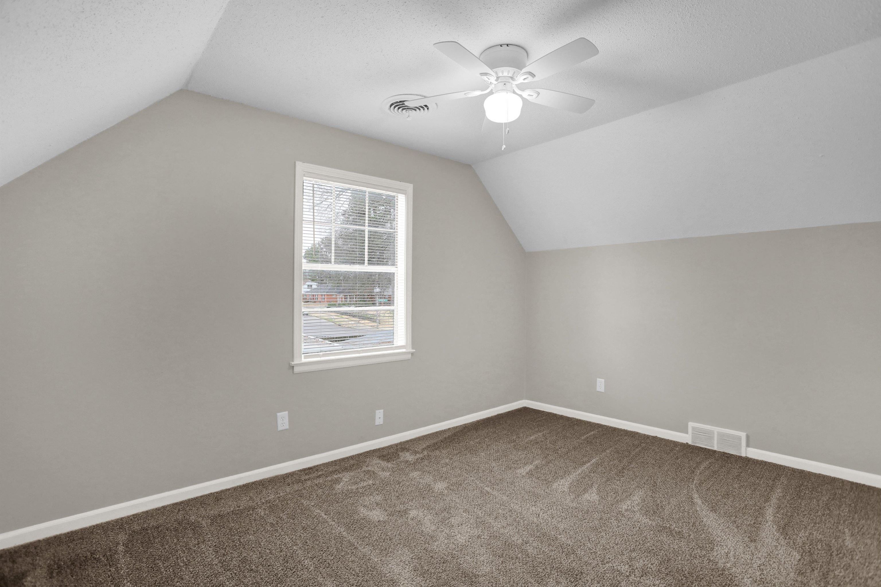 2853 Clearbrook Street Memphis, TN 38118 - Photo 28 of 30 Bonus room with baseboards, vaulted ceiling, visible vents, and dark colored carpet
