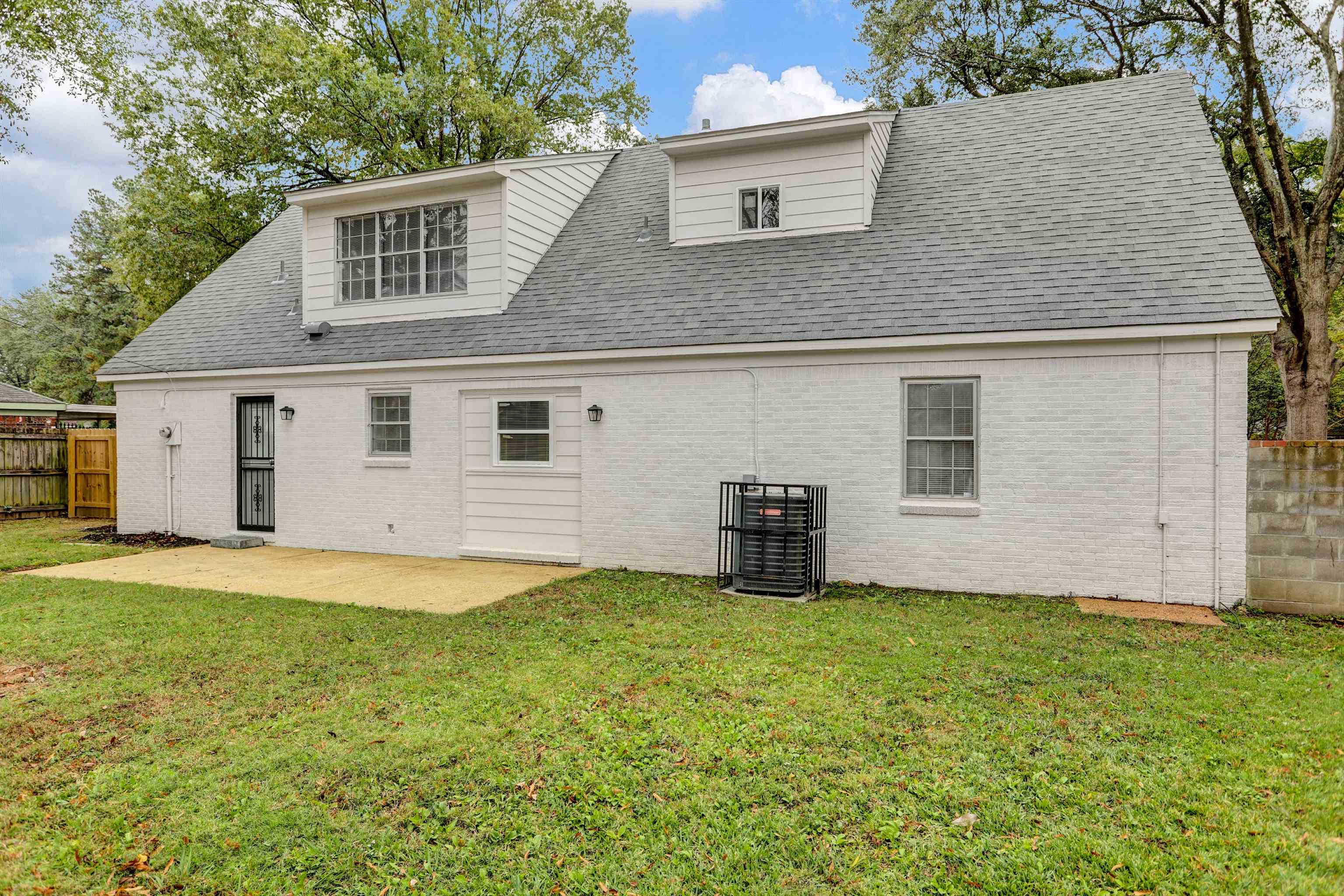 2853 Clearbrook Street Memphis, TN 38118 - Photo 30 of 30 Back of house with brick siding, a lawn, and fence
