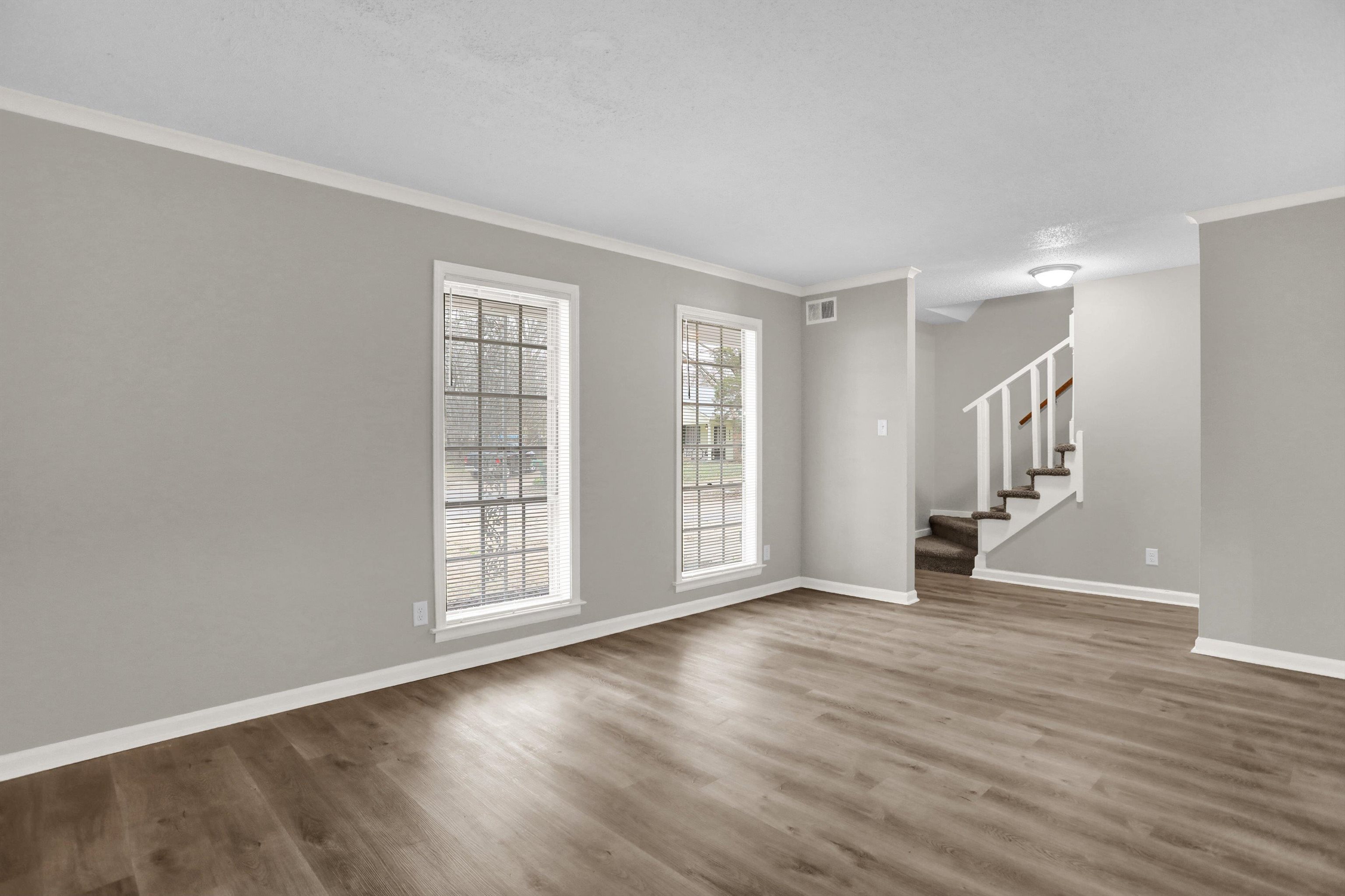 2853 Clearbrook Street Memphis, TN 38118 - Photo 4 of 30 Unfurnished room with wood finished floors, crown molding, baseboards, and stairs