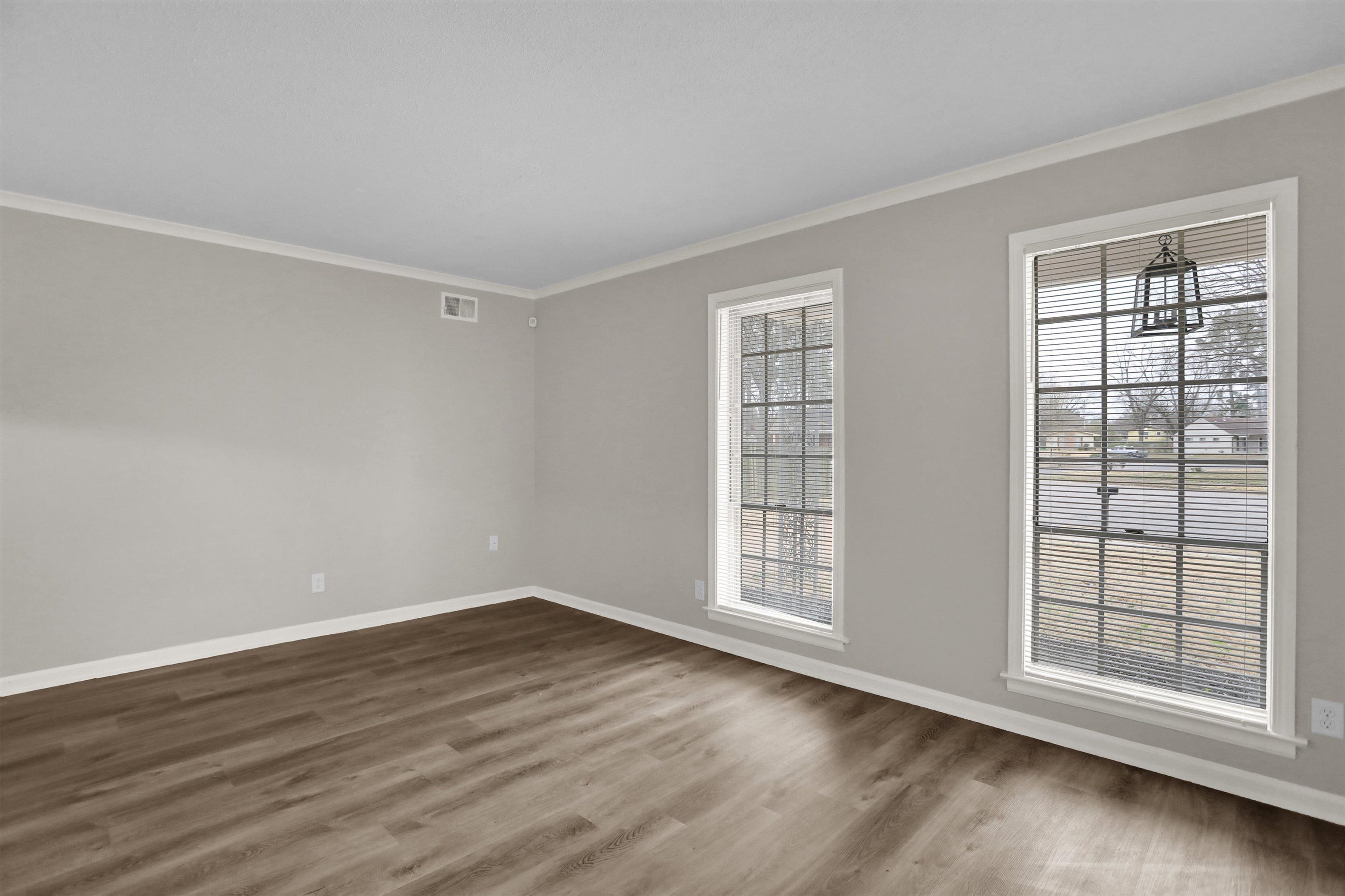 2853 Clearbrook Street Memphis, TN 38118 - Photo 5 of 30 Spare room featuring baseboards, visible vents, ornamental molding, and dark wood-style flooring